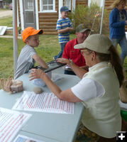Picking door prize winners. Photo by Dawn Ballou, Pinedale Online.