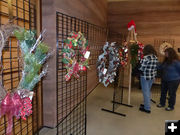 Looking at the wreaths. Photo by Dawn Ballou, Pinedale Online.