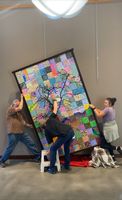 David Klarn, Mason Orm, and Mae Orm installing the tree piece (Resilient Vitality) in the Pinedale Library. 