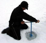 Drilling an ice fishing hole